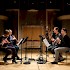 Sophie Cherrier, flute; Didier Pateau, oboe; Jérôme Comte, clarinet; and Paul Riveaux, bassoon, rehearsing Elliott Carter